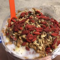 Coconut bowl topped with banana, blueberry and pineapple, plus goji berries, almond butter and alll the seeds!  at TropiBowls in Oakland Park