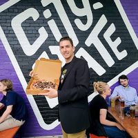 Eating Pizza Loko outside of City State at Pizza Loko in Washington