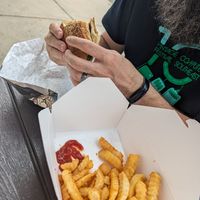 Hot and spicy chicken sandwich with fries at Dee's Vegan To-Go in Charlotte
