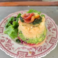 Causa limeña a base de papa macerada en Lima, rellena de palta y vegetales frescos at Con Sentido in Barra De Valizas
