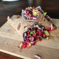 Burrito relleno de humus de porotos negros, plata, salsa criolla y remolacha at Con Sentido in Barra De Valizas