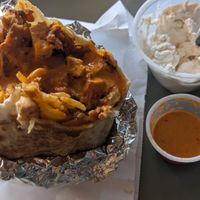 Vegan burrito, side of sour cream and medium hot sauce at Habanero Burrito - Food Cart in Portland