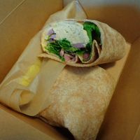 Herbed Hummus Wrap.  housemade roasted garlic + herb hummus, arugula, pickled onion, lemon vinaigrette  at Buckeye Chocolate Café Bainbridge in Auburn