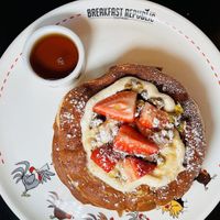 Vegan Tres Leche Pancakes: Vanilla pancakes, vegan sweet buttercream, almond, coconut, and oat milk syrup, and fresh strawberries topped with pistachio brittle. Insanely good!   at Breakfast Republic in Costa Mesa