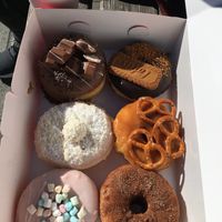 Vegan Lotus Cookie Donut with chocolate filling, caramel pretzel donut & cinnamon-sugar filled with apple sauce  at Royal Donuts in Augsburg