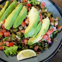 Bowl with herb rice, greens, avocado, cactus, black beans, pico, and cilantro. at Comālli Taqueria in Reading