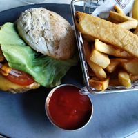 Burger was great! But look at that rock of a bun!! at Willow Vegan Bistro in New York City