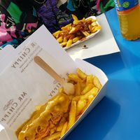 Vegan sausage and chips with curry sauce. (And vegan chips n gravy behind) at Mr Chippy in York