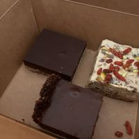 Millionaire shortbread, white chocolate, fig and walnut square with goji berries and my fave hazelnut and chocolate tart  at The Conscious Kitchen - Kloof St in Cape Town