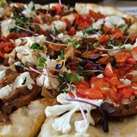 Peace-zza with vegan chicken, cauliflower, peppadews. Super delicious and big sized enough to feed one very hungry person or two persons with medium hunger. at The Conscious Kitchen - Kloof St in Cape Town