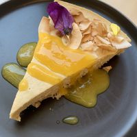 Coconut and mango cheesecake at Nato Comé Real in Rosario