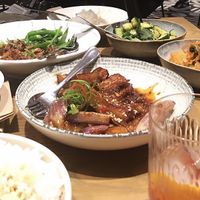 Glazed chilli eggplant with black pepper tofu (left) and kimchi and cucumber salad (right). at east in Auckland