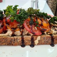 Smash white beans, tomato, balsamic and crispy Kale🤤 at Pink Neon Sign in Auckland