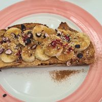 Banana with peanutbutter hemp seeds maple syrup and cinnamon so yum! at Pink Neon Sign in Auckland