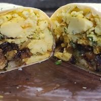 Breakfast Burrito with chorizo sausage and truffle chive potatoes, pepperjack melted just egg at Crystals Soul Cafe in Los Angeles