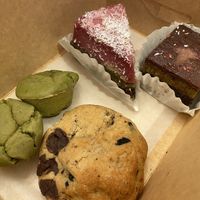 Mochi buns (left), 3 layer cake (top), pistachio cake (right), chocolate chip cookie (bottom)  at Level V Bakery in Vancouver