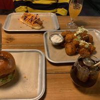 Vegan burger, vegan hotdog and temple of seitan cauliflower wings. Both drinks are vegan-friendly also (brewdog draught beer and rum + coke). at BrewDog in Budapest