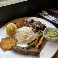 rice, portobello and grilled vegetables, plátano spider with guacamole, house chorizo and chicharrón  at Veggie Beans and Shakes in Bogota