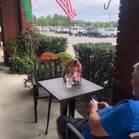 Very cozy seating outside with pretty foliage - felt like I was in a garden! at Seaside Bagels in Wilmington