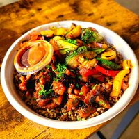 Quinoa bowl with BBQ carnitas and orange sauce at Roasted and Raw in Oakland