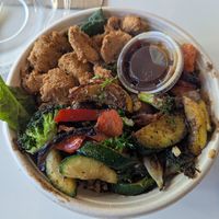 Orange teriyaki bowl with chik'n on a bed of greens and quinoa at Roasted and Raw in Oakland