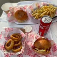 Classic burger and onion rings in the front and notorious B.I.G and garlic fries in the back. I really recommend the burgers. at Dirty V - Bergen in Bergen