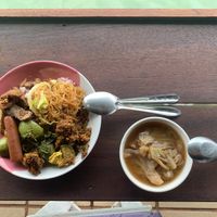 A mix of spicy and non-spicy dishes on mixed rice with a basic vegetable soup. The food wasn’t hot, but it was flavourful. at Tamachat Vegan Food - ธรรมชาติ in Koh Samui
