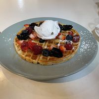 Picnic Cafe’s Mixed Berries waffle, with maple syrup and vegan vanilla ice cream. at Picnic Cafe in Hobart