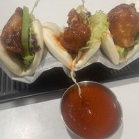 Herbivore bao with side of siracha. The Korean fried cauliflower is outstanding!   at Po-Ké Ono in Oranjestad