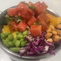 Watermelon Poke bowl with mango, avocado, edamame, crispy corn, wakame, sweet potato, pickled cucumber, red cabbage, sweet chili dressing tossed in tamari poke dressing.  at Po-Ké Ono in Oranjestad