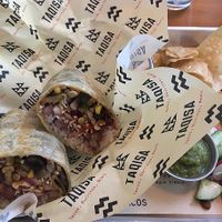 Vegan mushroom burrito with chips and green salsa at Taqisa in Denpasar