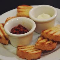 Bread plate with sundried tomato, the other isn't vegan at Eatcetera in Galveston
