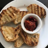 Complimentary appetizer of toasted bread (vegan) along with a spread (vegan) at Eatcetera in Galveston