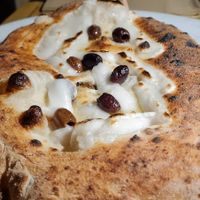 Filled pizza with endives, olives, and capers. at Osteria Casa Pepe in Trieste