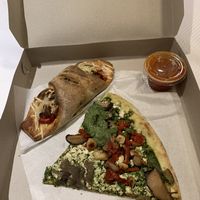 Vegan zen slice and vegan sausage and peppers calzone at Cafe Viva in New York City