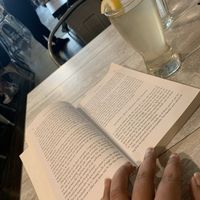 Coconut water and a book. Perfect combo for the summer  at Candle Cafe in New York City