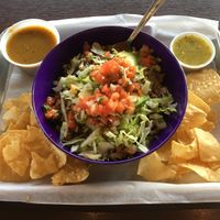 Vegetarian Crumble Bowl (vegan as is) with Tomatillo salsa (right). Side of chips and Rajas salsa (left). The plant-based crumble is wonderfully seasoned. Great home-made salsas. at El Camino Gourmet Tacos in Edina