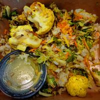 Golden Veggie Bowl 2024. Brown rice, roasted cauliflower, shredded carrots + parsnips, roasted brussels, sunflower seeds, golden onion vinaigrette. Vegan.  at Chardon Buckeye Chocolate Café in Chardon