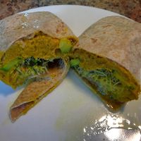 Sweet Potato Hummus Wrap. Sweet potato hummus, roasted shallots, cucumber, sprouts, lemon vinaigrette. Filling and lots of napkins recommended.  at Chardon Buckeye Chocolate Café in Chardon