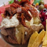 Baked potato with hummus & sun dried tomatoes at Cafe U in Kelso
