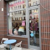 One table outside and Happy Cow decal on window!  at Baja Wegańska Cukiernia in Warsaw