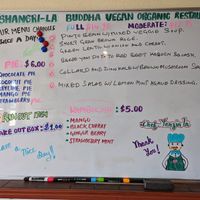 Menus are outside and inside on this whiteboard, changed twice a day at Shangri-la Buddha in Albany
