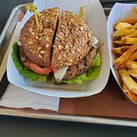 Bean burger with tomato, lettuce, vegan cheese, and a side of french fries at Sandwich in Camp Hill