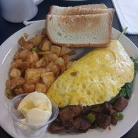 Vegan omelette with steak, mozzarella, mushrooms, and spinach. White toast with vegan butter and diner potatos. at Black & Blue Diner in Las Vegas