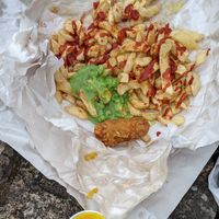 Chips with nice vegan battered sausage, nice vegan curry sauce, disappointing peas at Milton Chippy in Stoke-on-trent
