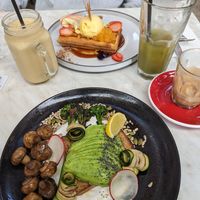Avocado on toast with mushrooms on the side. Waffles in the back. at Hydrant Food Hall in Ballarat