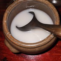 Ozeki Nigori unfiltered sake, cold, served in ceramic bowl and cups - go delicious! at HanGawi in New York City