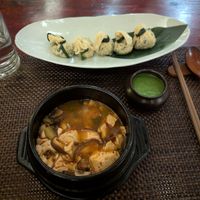Spicy soft tofu soup (superb) and tofu skin dumplings with edamame dipping sauce (delicious) at HanGawi in New York City