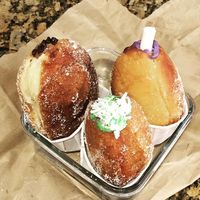 The Chocolate (top l), the Japanese sweet purple yam, and thePandan malasadas.  at SPLIT Bakehouse in La Mesa