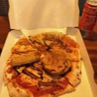 Pizza with vegan bacon with vegan battered saussie and burger on it at VeGrill - Pop up in Dublin
